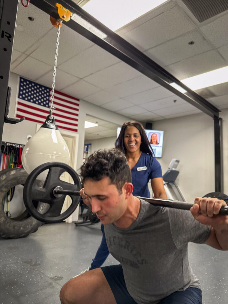 Dr. Michelle is shown proper lifting technique physical therapy demonstration
